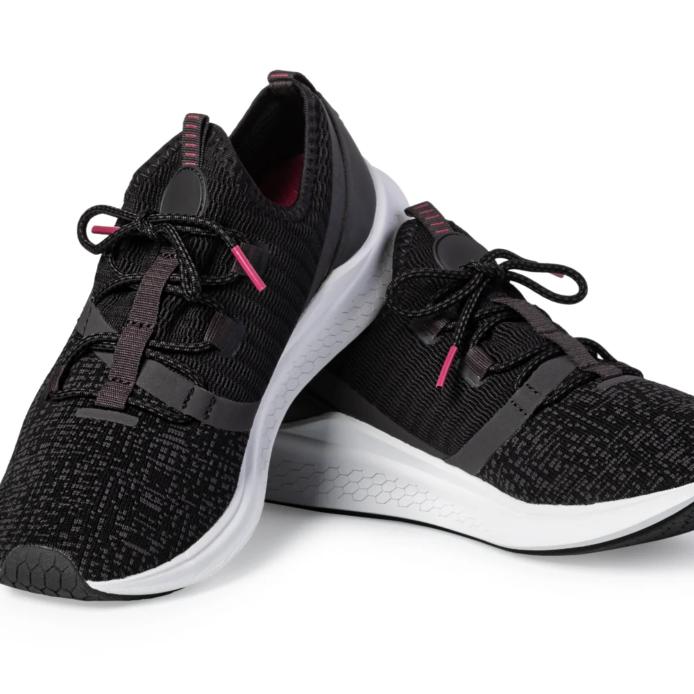 Black padel trainers with white soles designed for comfort and grip on court.